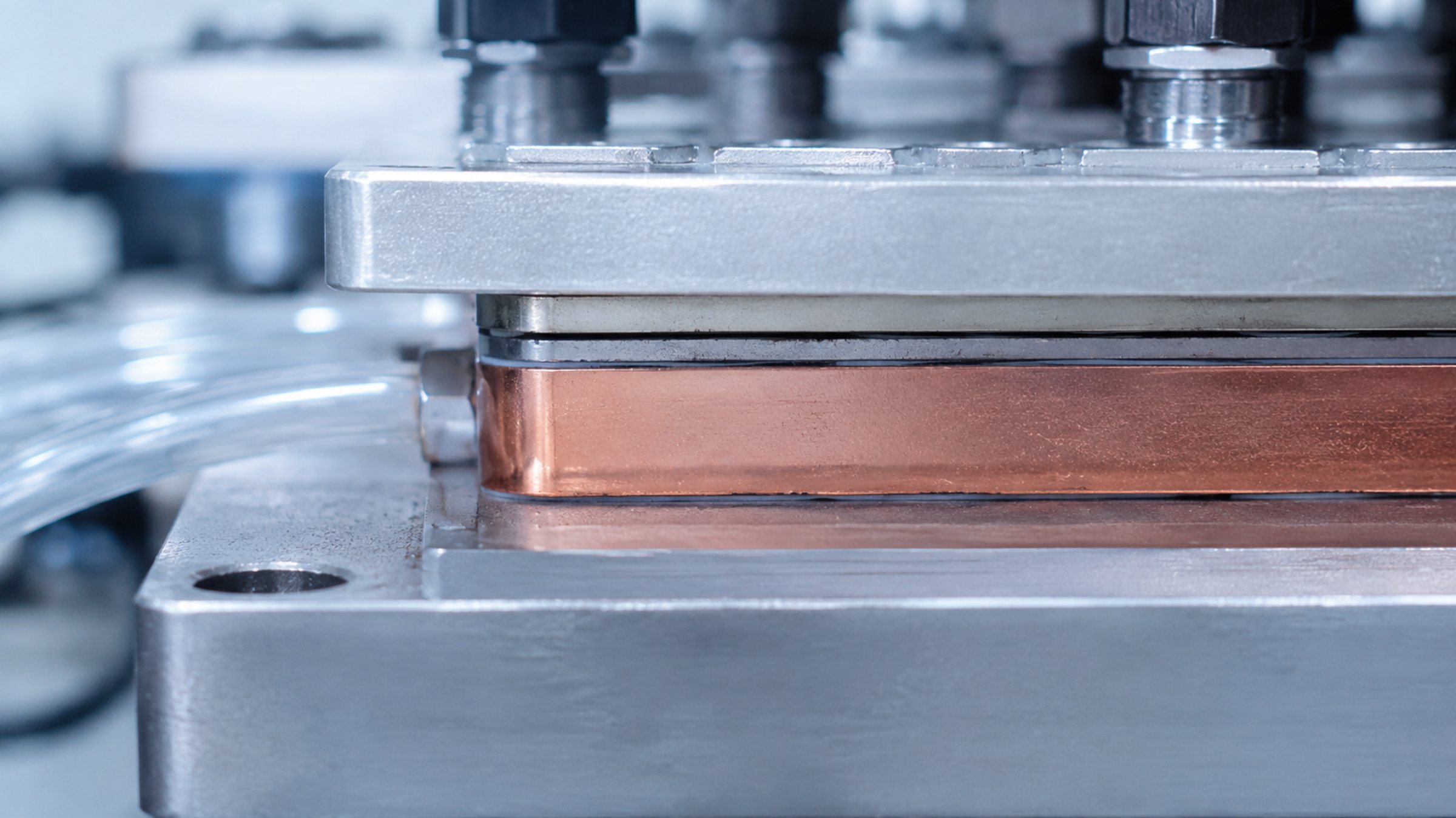 Heat moving from a dense compute package through a thermal interface into a liquid path.